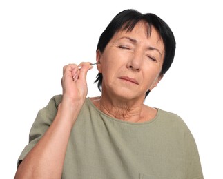 Photo of Senior woman cleaning ear with cotton swab on white background