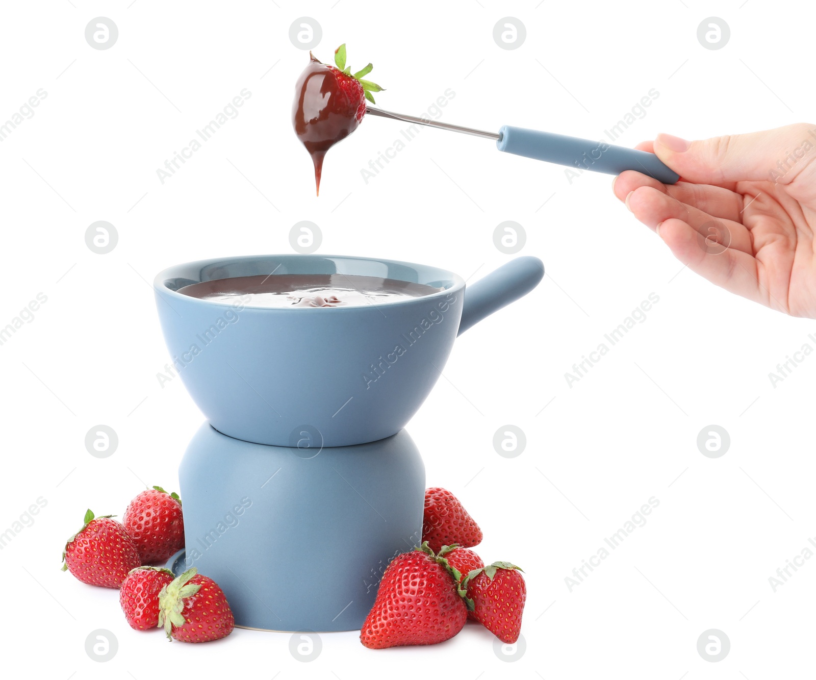 Photo of Woman dipping strawberry into fondue pot with chocolate on white background, closeup