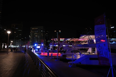 DUBAI, UNITED ARAB EMIRATES - NOVEMBER 03, 2018: Pier with luxury yachts at night