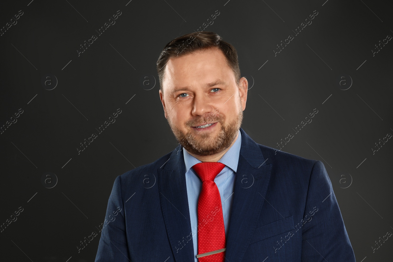 Photo of Portrait of happy mature man on black background