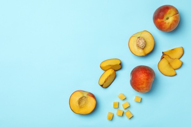 Photo of Flat lay composition with sweet juicy peaches on light blue background