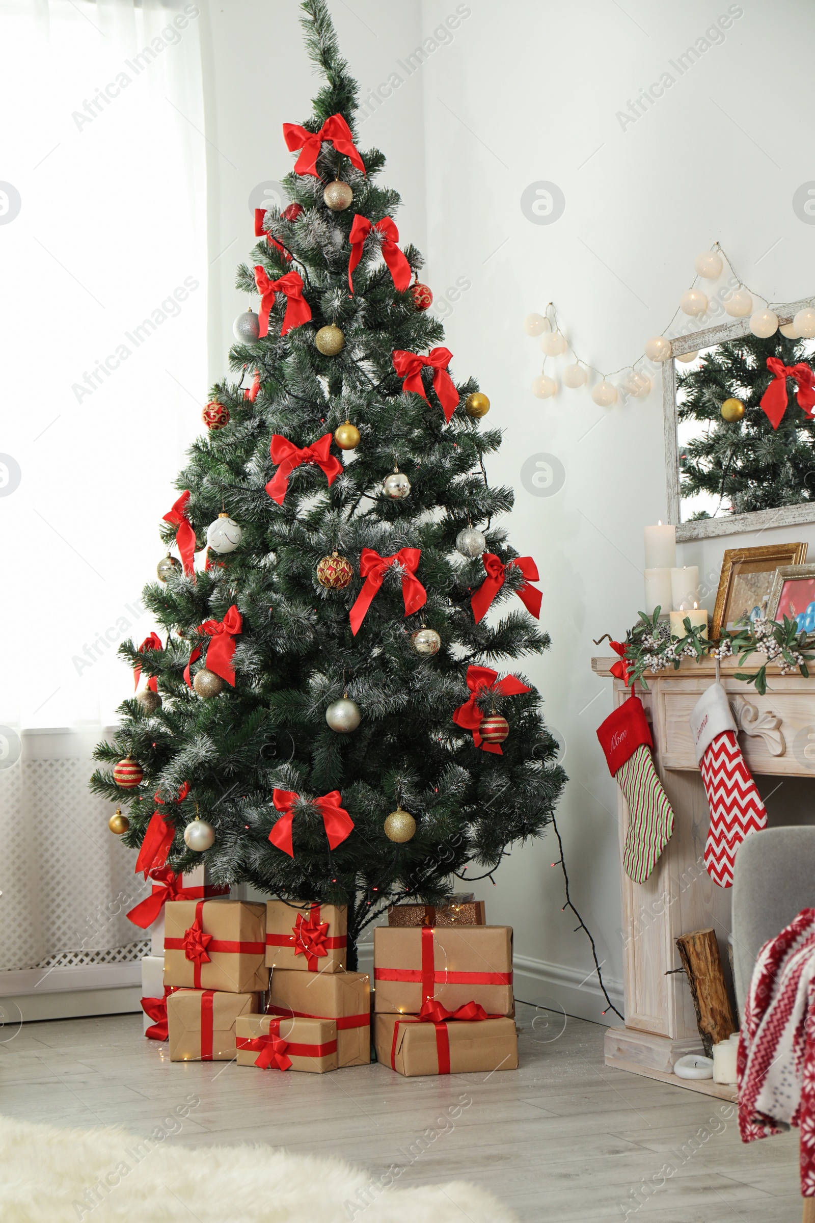 Photo of Decorated Christmas tree in stylish living room interior