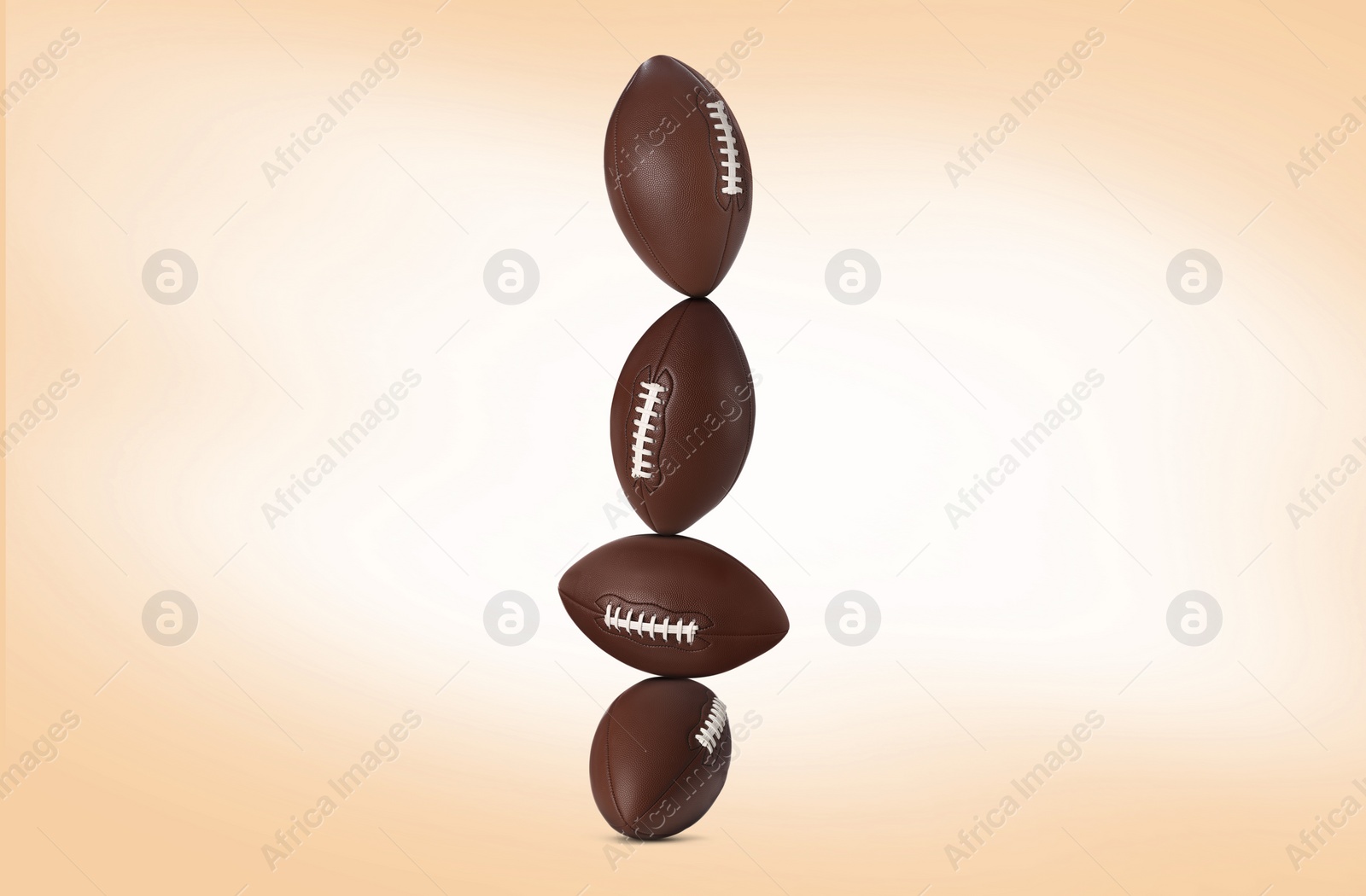 Image of Stack of rugby balls on beige background