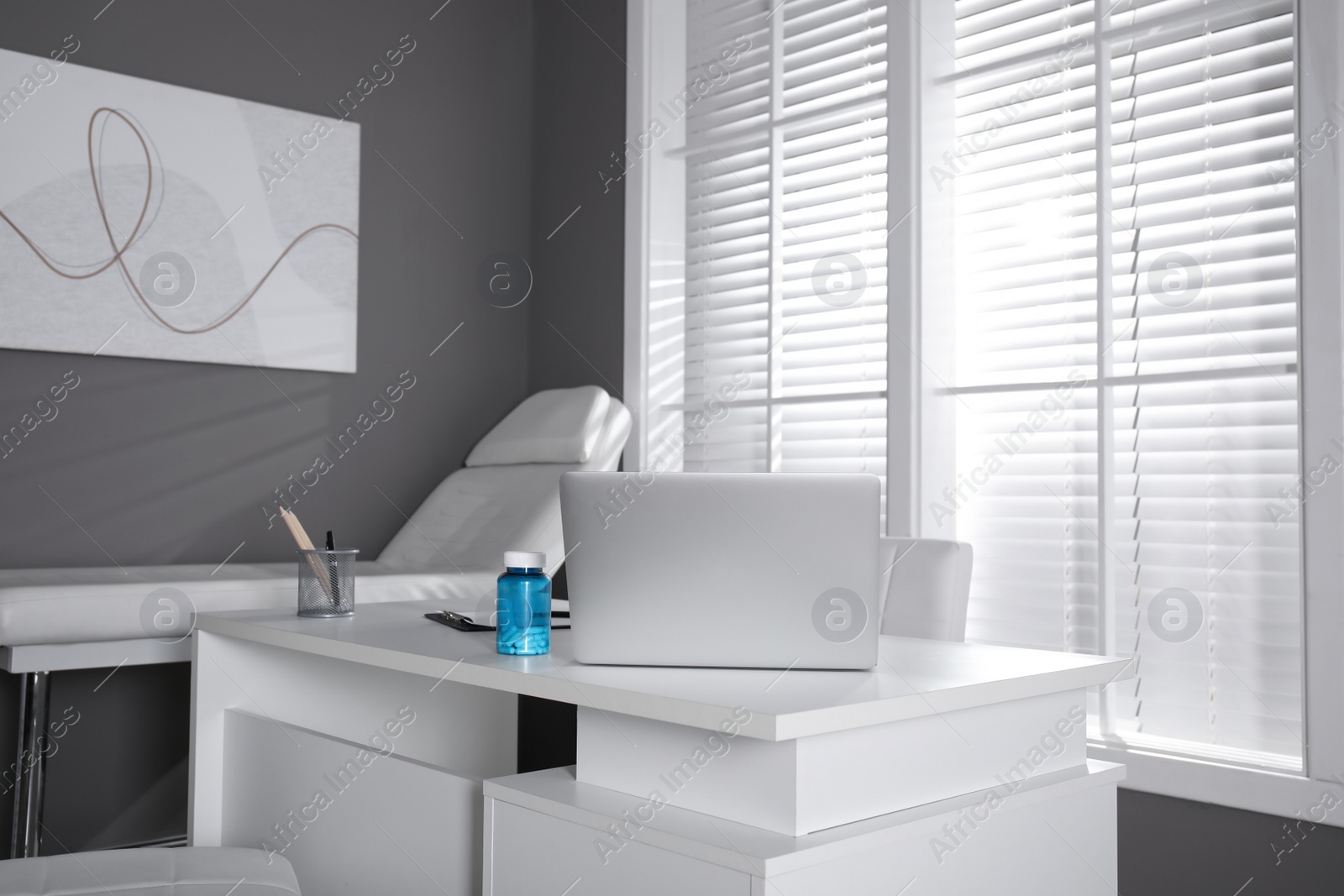 Photo of Modern medical office interior with doctor's workplace