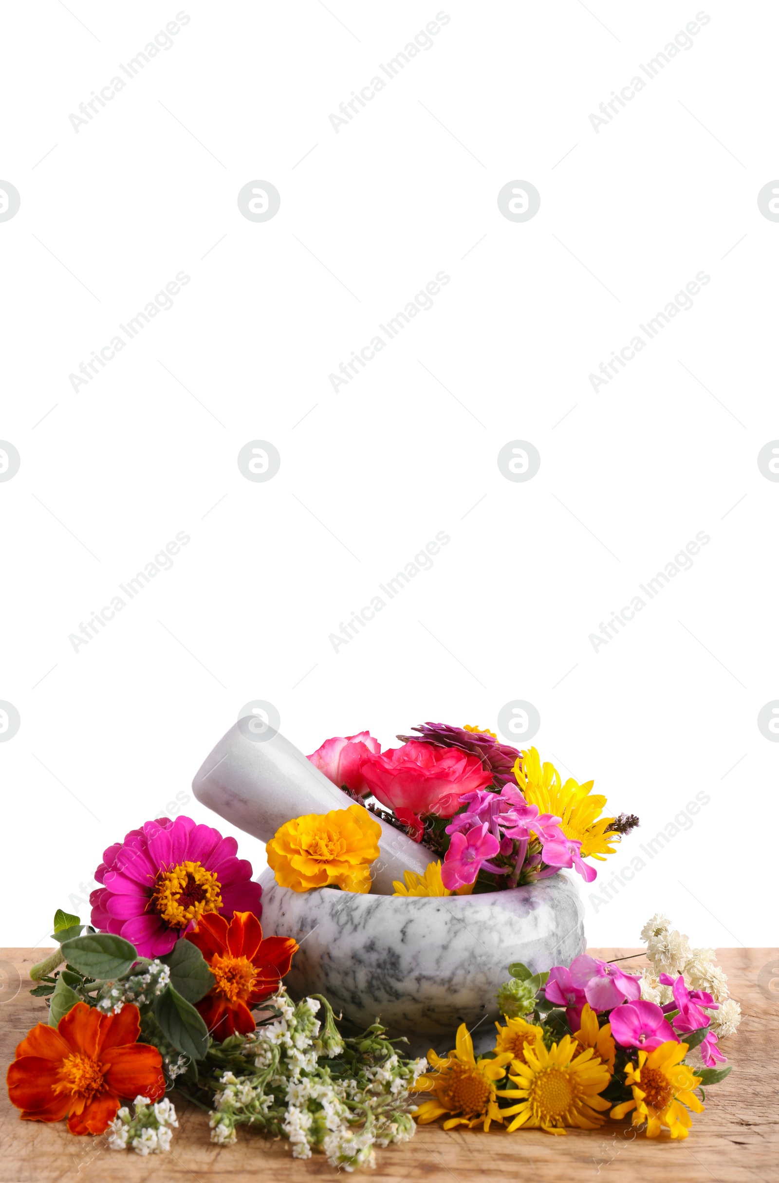 Photo of Marble mortar, pestle and different flowers on wooden table against white background. Space for text