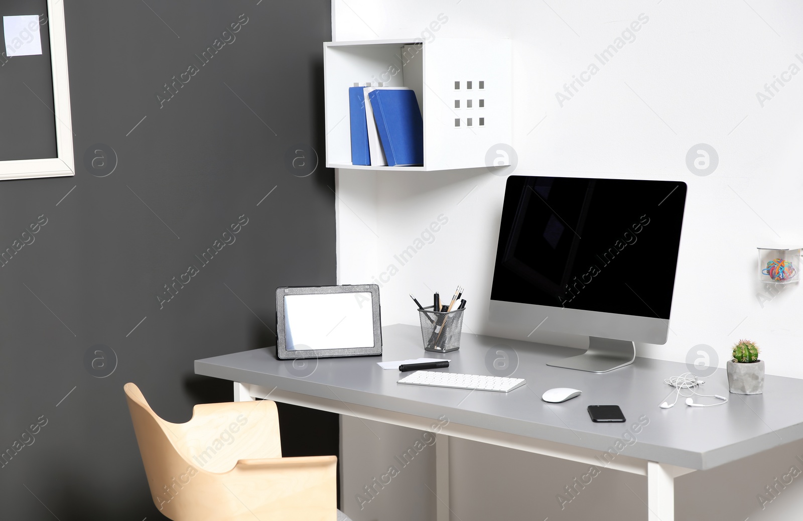 Photo of Modern interior of workplace with computer and accessories