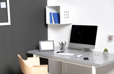 Modern interior of workplace with computer and accessories