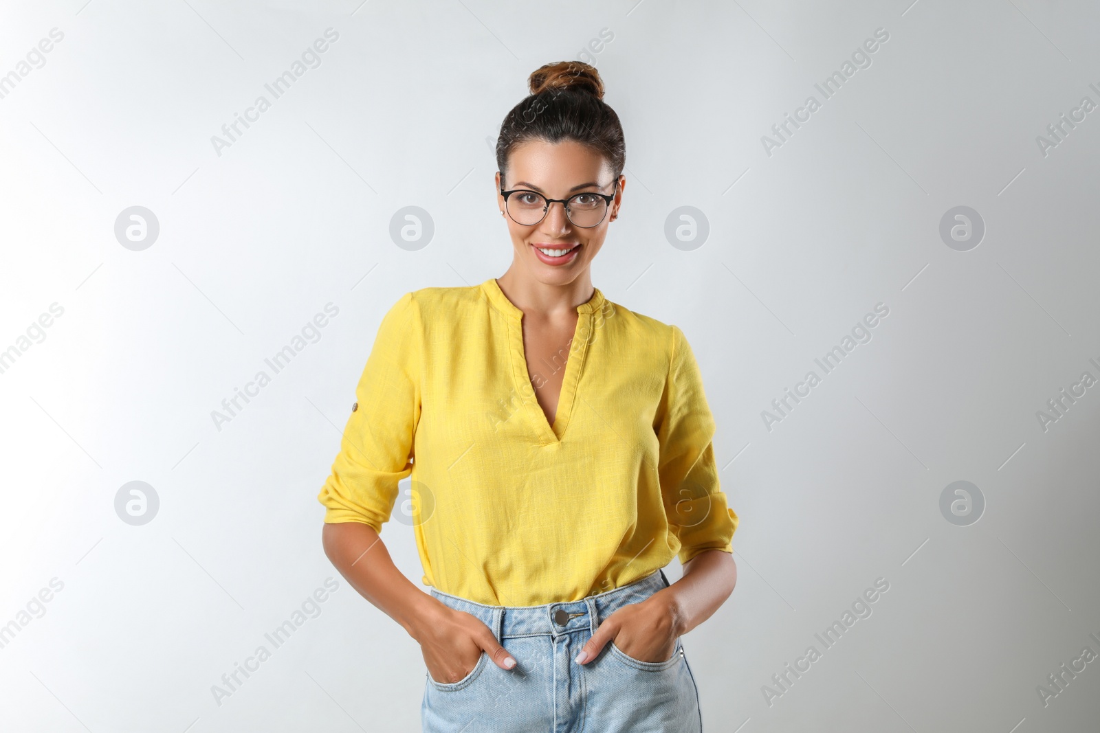 Photo of Beautiful woman in eyeglasses on white background