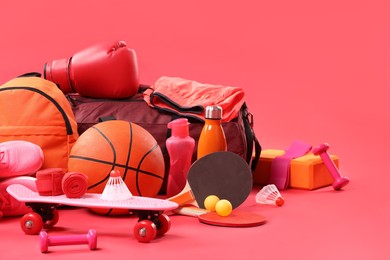 Photo of Many different sports equipment on red background