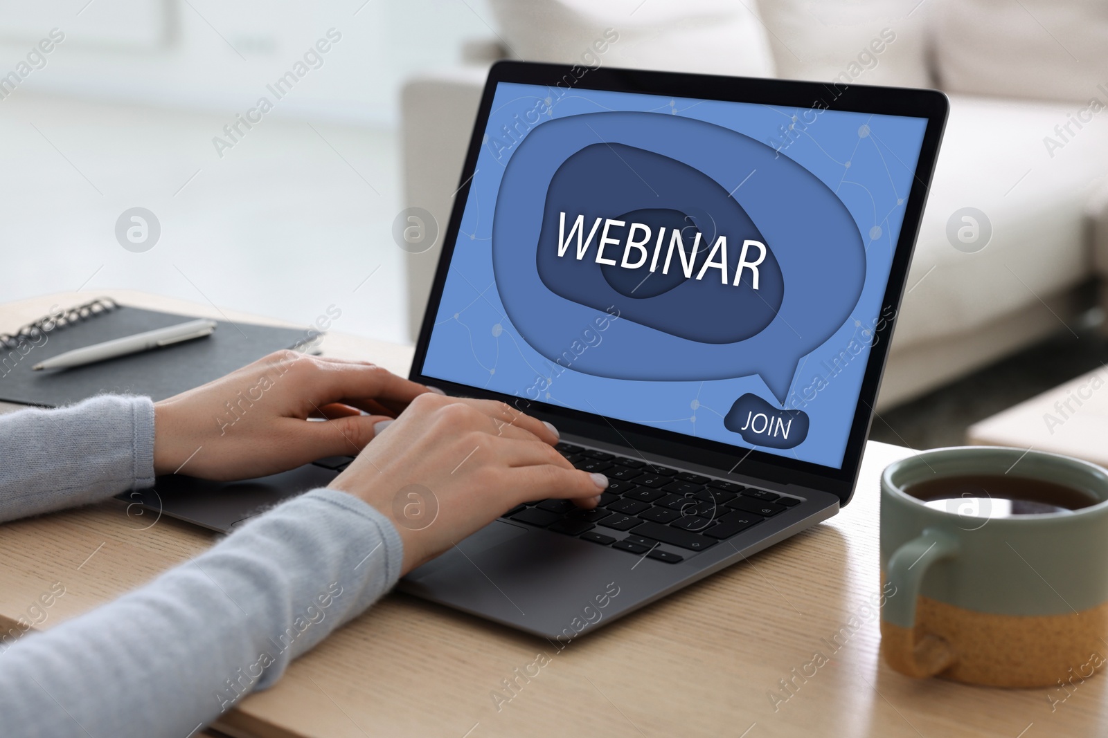 Image of Online webinar, web page on computer screen. Woman using laptop at wooden table, closeup