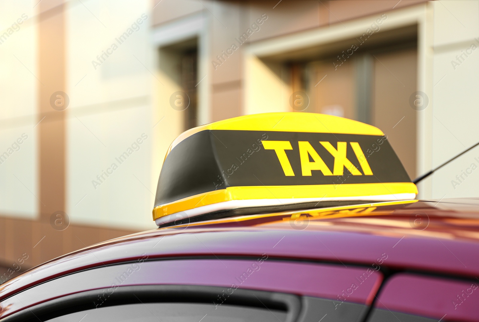 Photo of Roof light with word TAXI on car outdoors