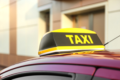 Roof light with word TAXI on car outdoors