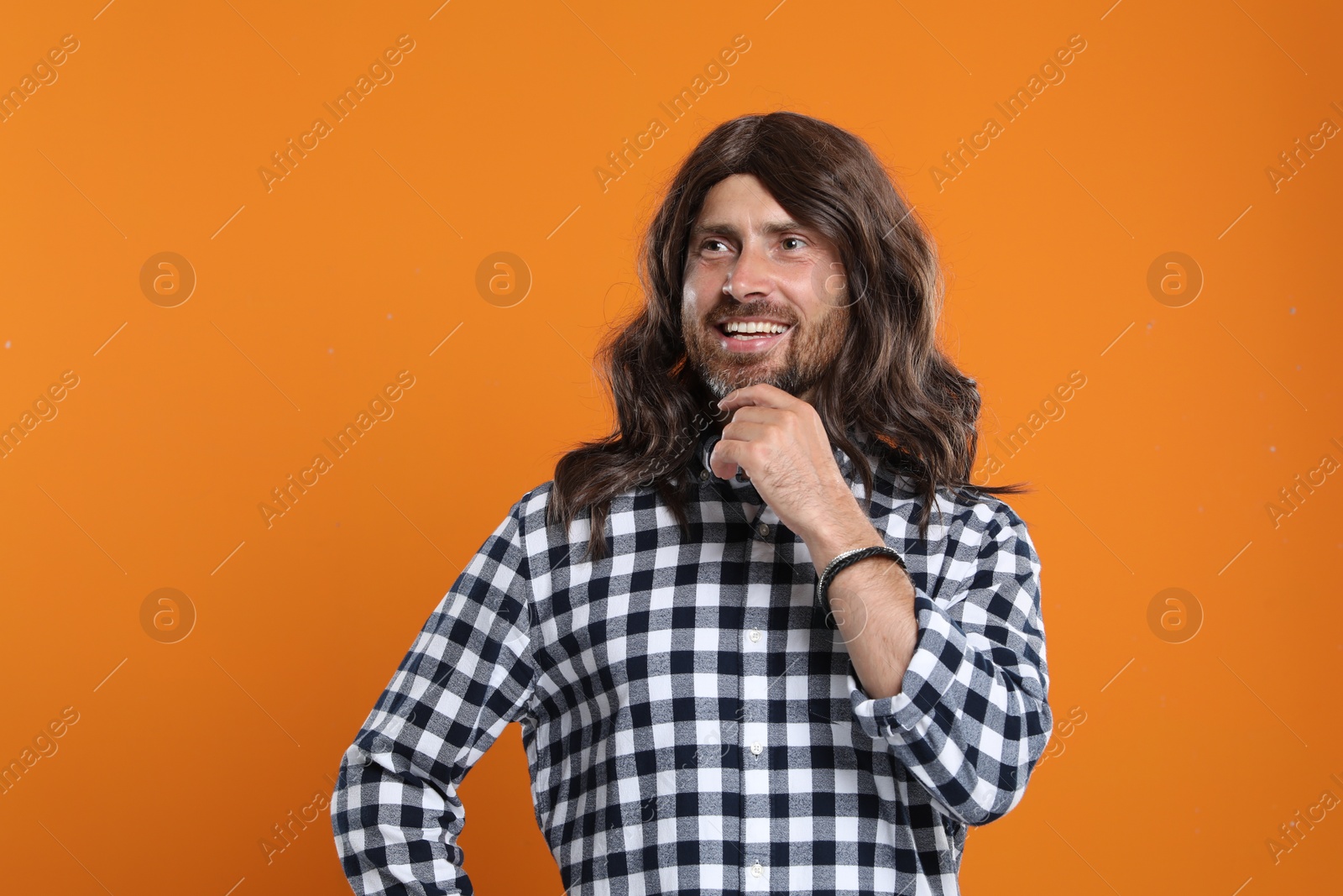 Photo of Hippie man in checkered shirt on orange background