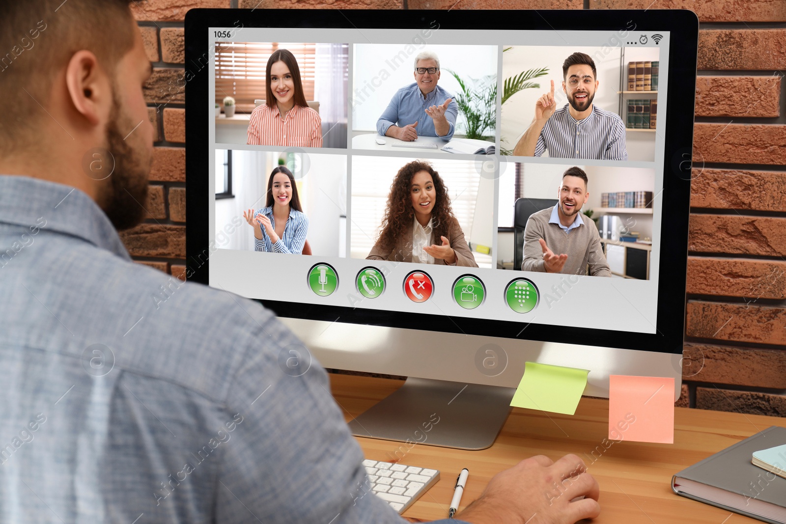 Image of Man having video chat with colleagues at table in office, closeup. Team work 