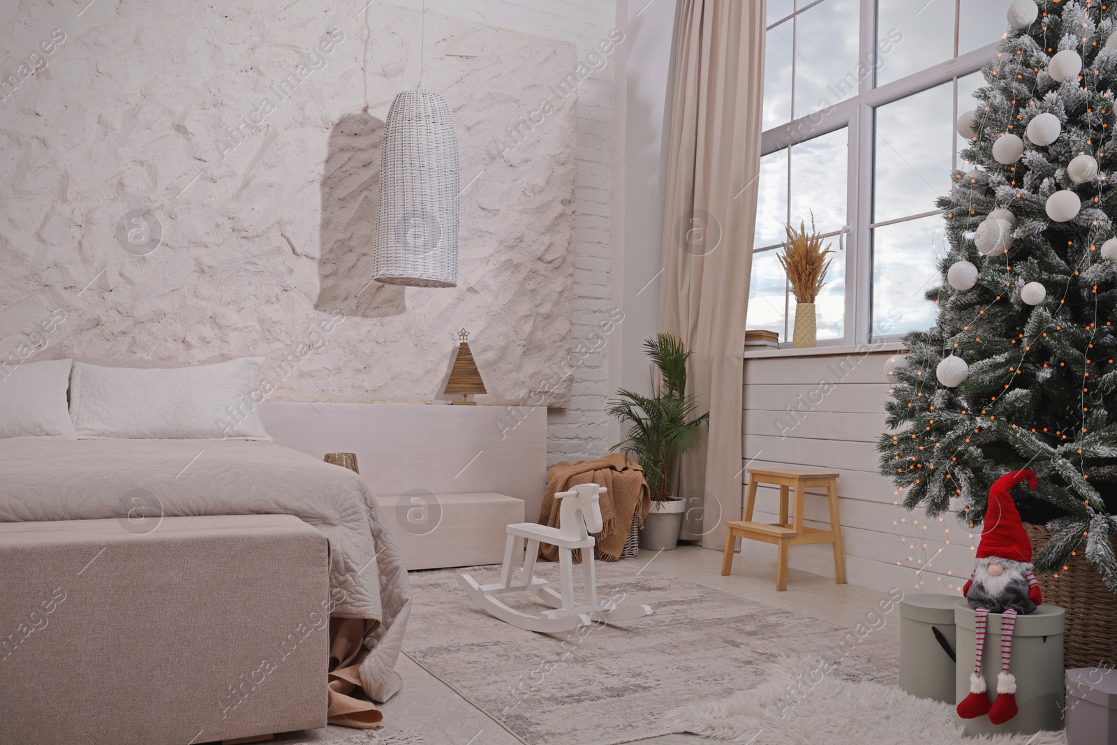 Photo of Bedroom interior with Christmas tree and festive decor