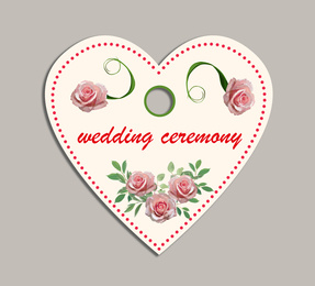 Wedding ceremony tag with floral design on grey background, top view
