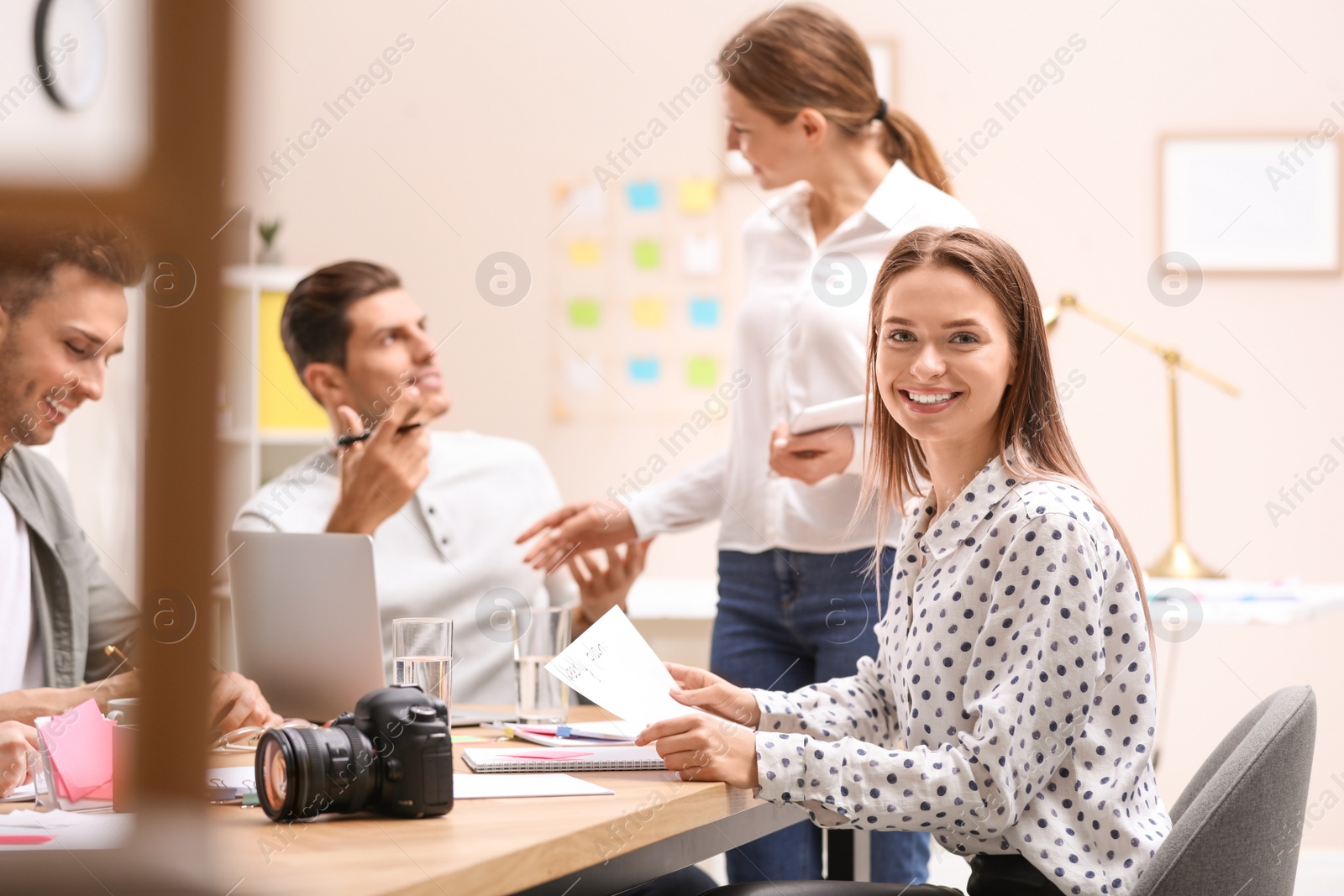 Photo of Team of professional journalists working in office