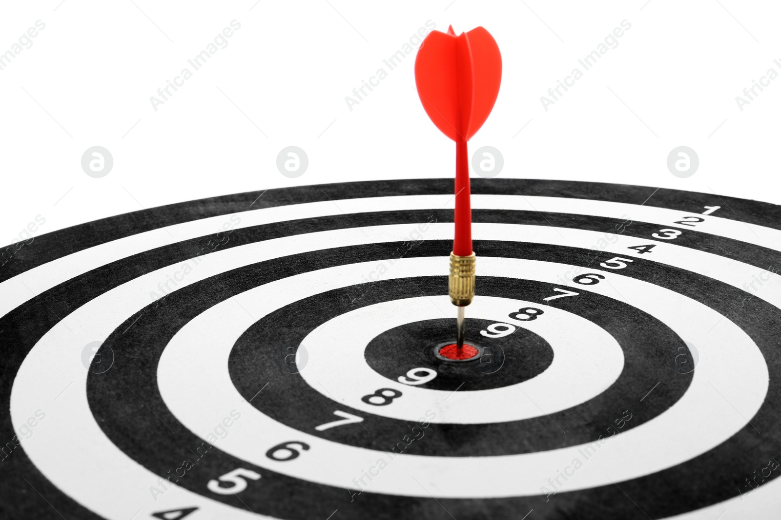 Photo of Red arrow hitting target on dart board against white background