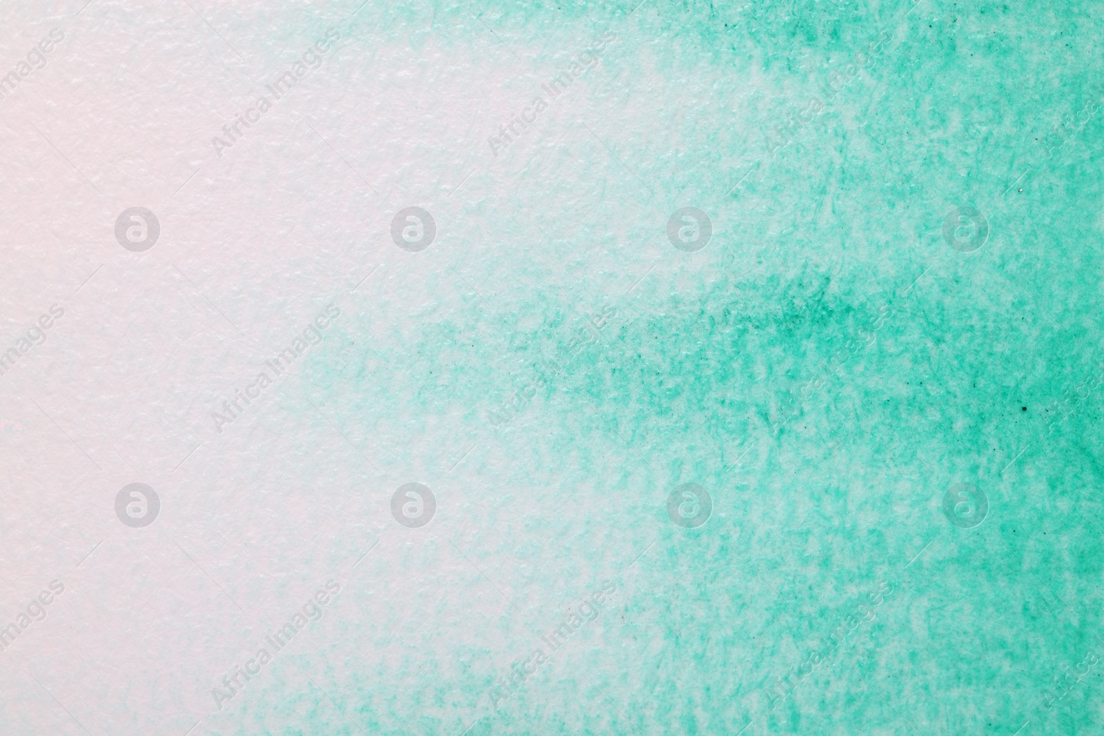 Photo of Abstract green watercolor painting on white paper, top view