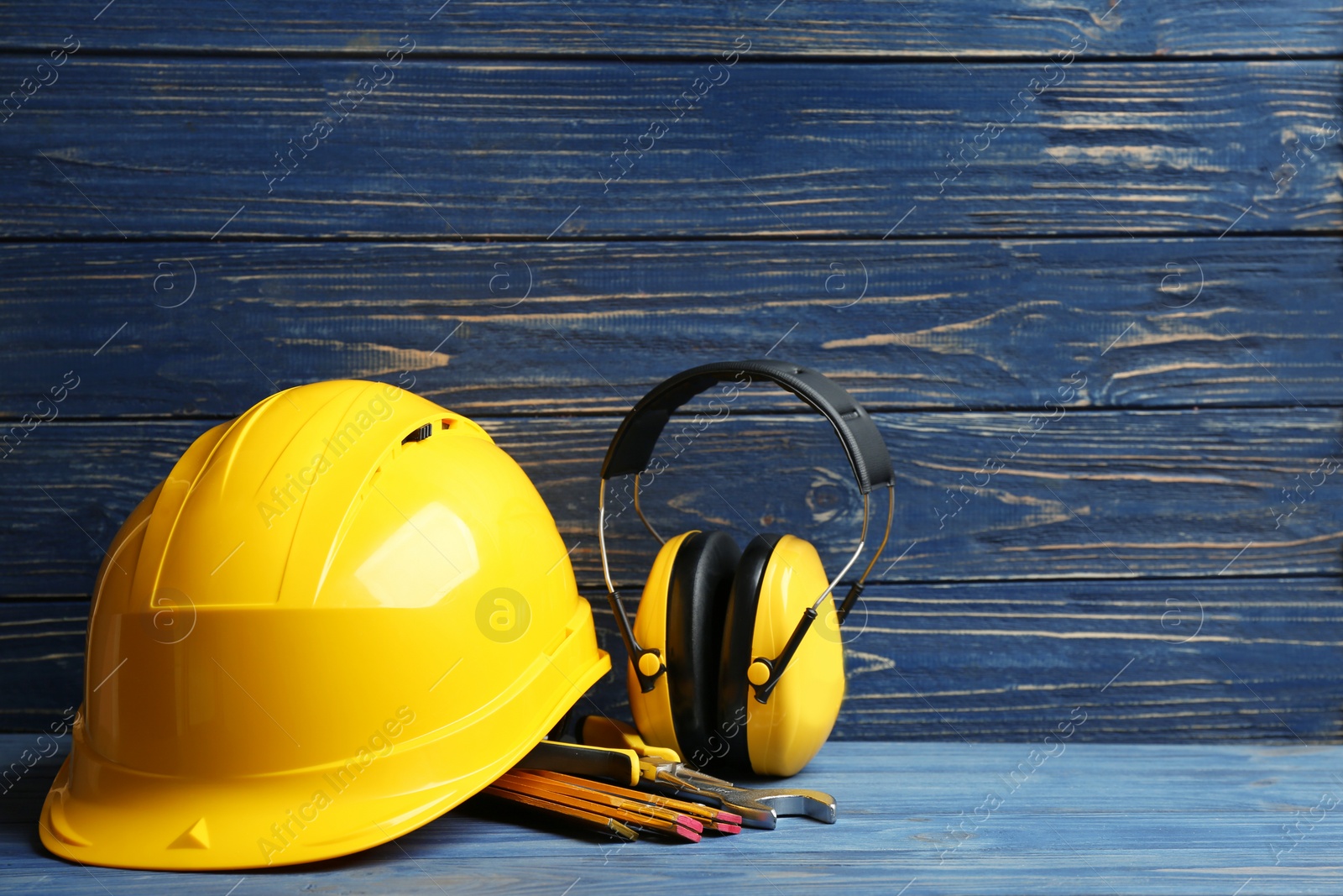 Photo of Composition with construction tools on table against wooden background, space for text