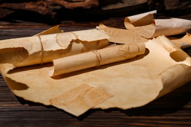 Sheets of old parchment paper on wooden table