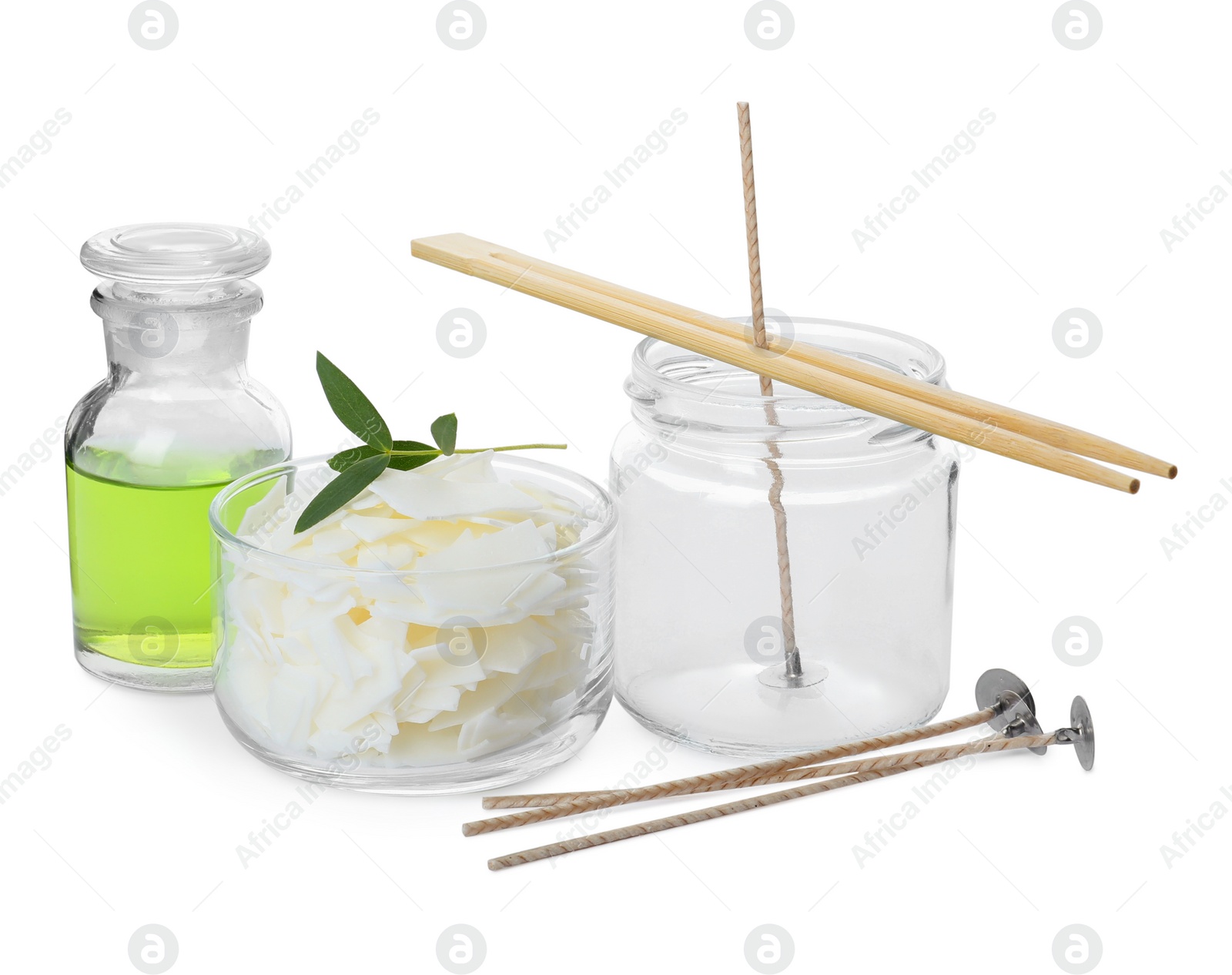 Photo of Wax flakes, essential oil and wicks on white background. Making homemade candle