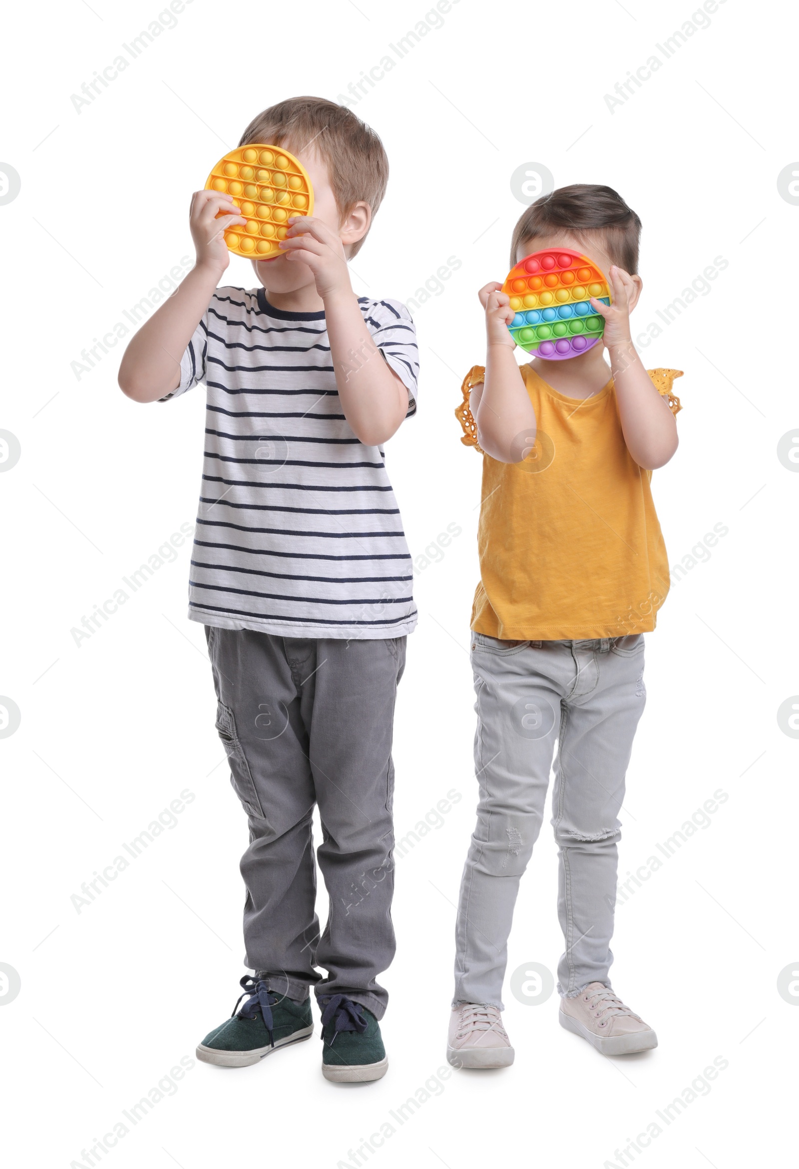 Photo of Little children with pop it fidget toys on white background