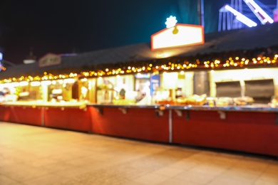 Blurred view of Christmas fair stalls outdoors at night