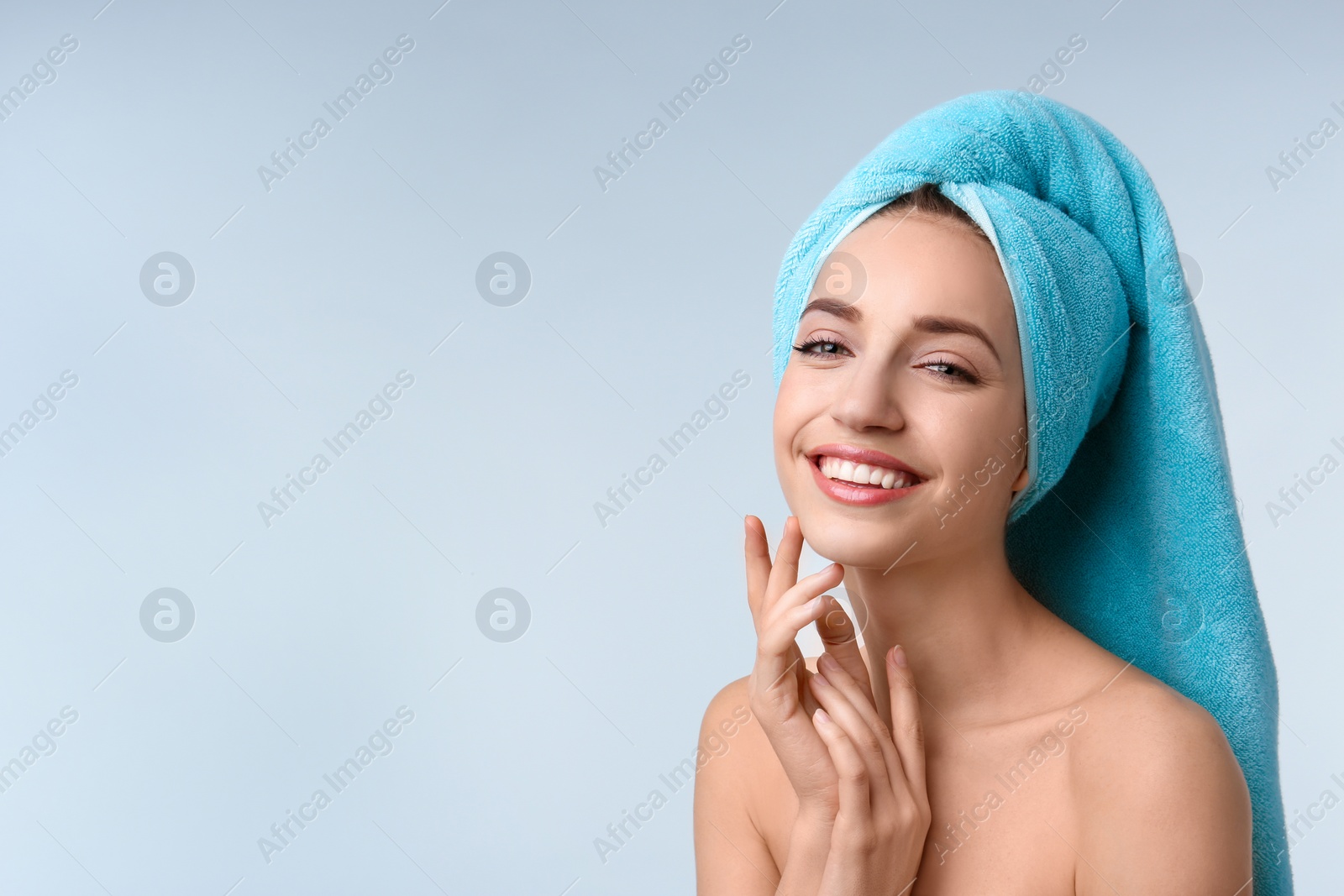 Photo of Beautiful young woman with silky skin on light background