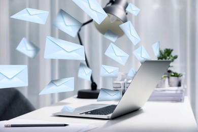 Image of Email spam. Workplace with laptop and many letters