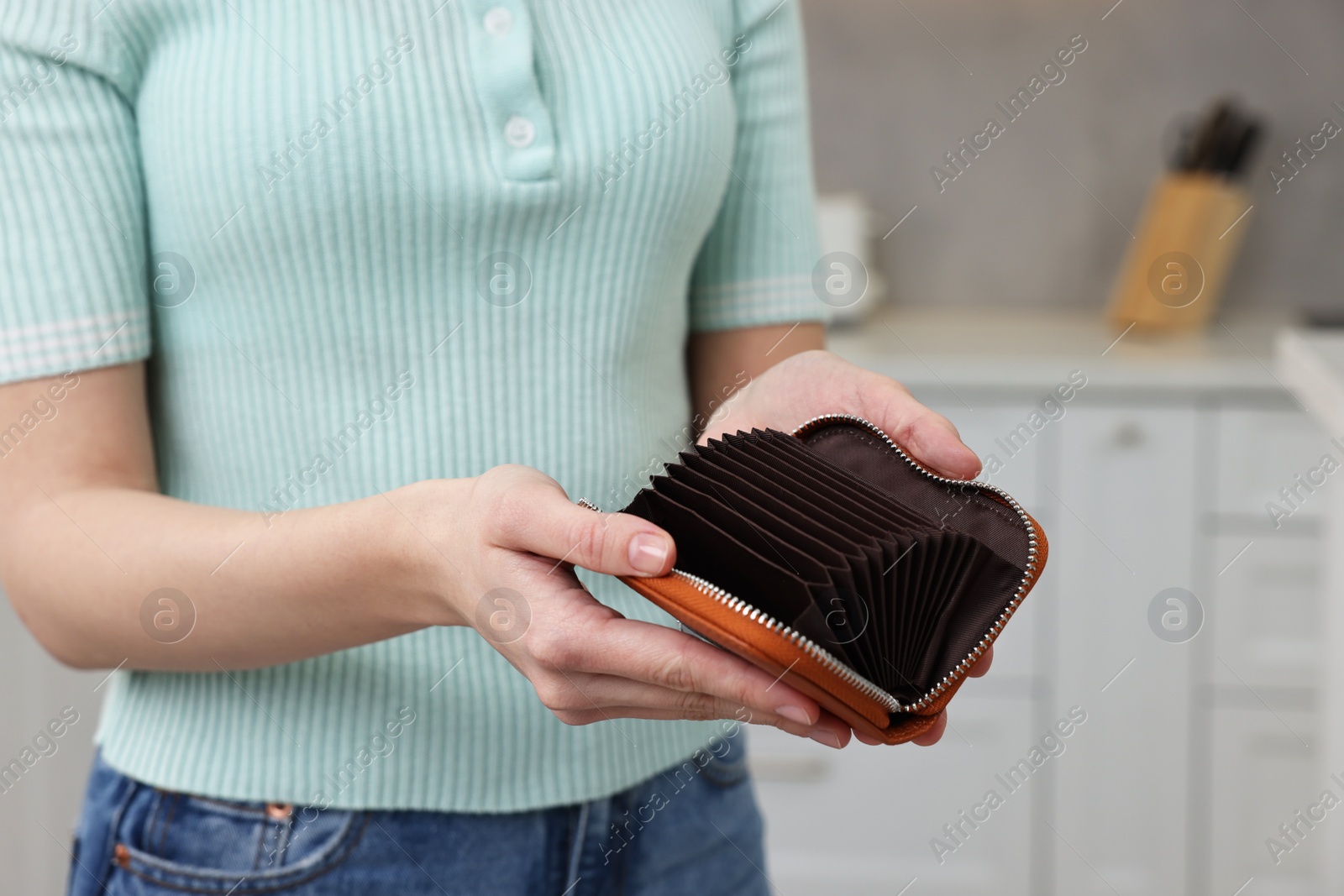 Photo of Woman with empty wallet at home, closeup