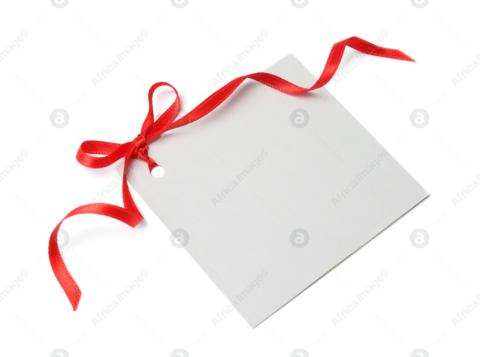 Photo of Blank gift tag with satin ribbon on white background