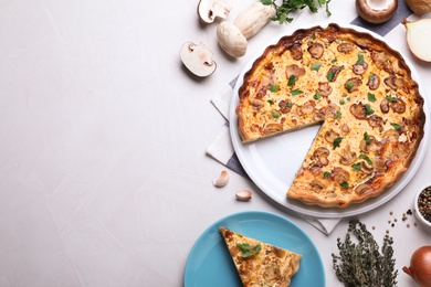 Delicious pie with mushrooms and cheese served on light table, flat lay. Space for text