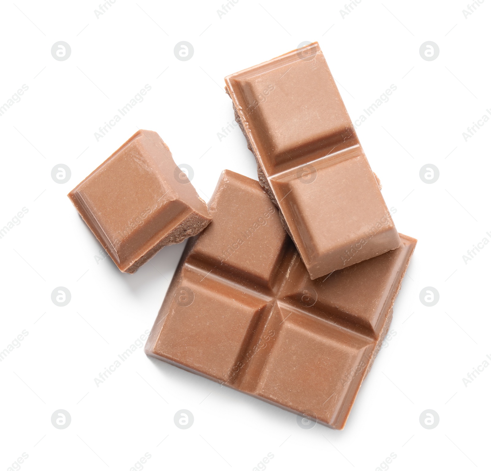 Photo of Pieces of delicious milk chocolate isolated on white, top view