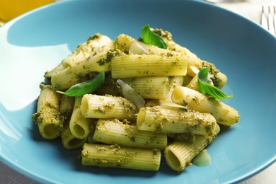 Photo of Delicious basil pesto pasta on plate, closeup