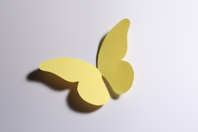 Yellow paper butterfly on light background, top view