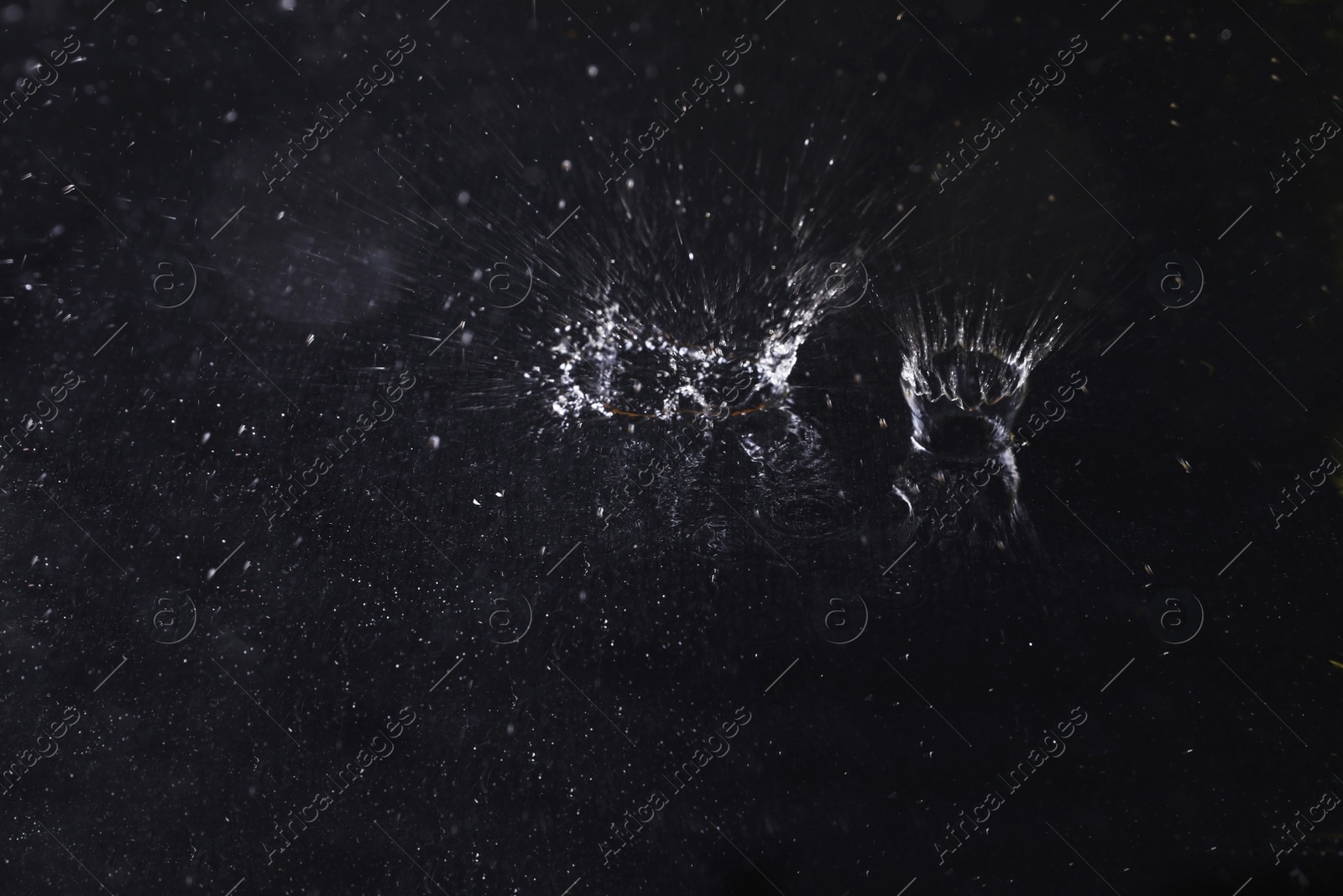 Photo of Splash of water on dark background. Rainy weather