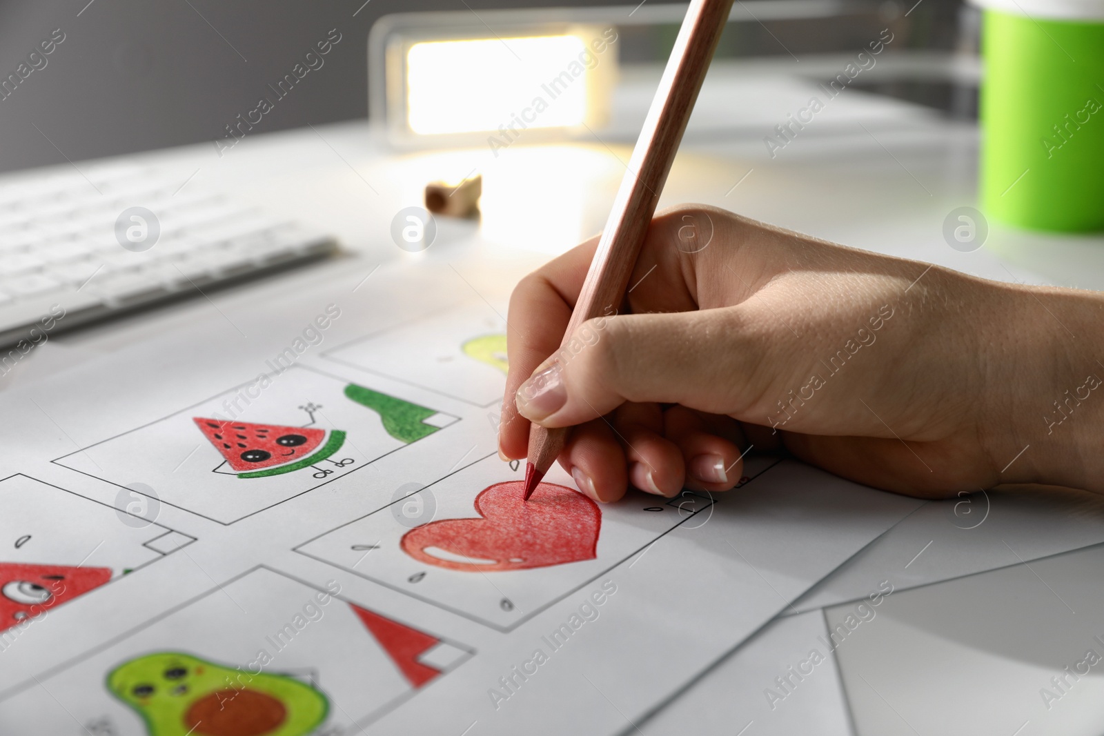 Photo of Woman drawing cartoon sketch at workplace, closeup. Pre-production process