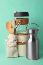 Photo of Composition with eco friendly products on turquoise background. Conscious consumption