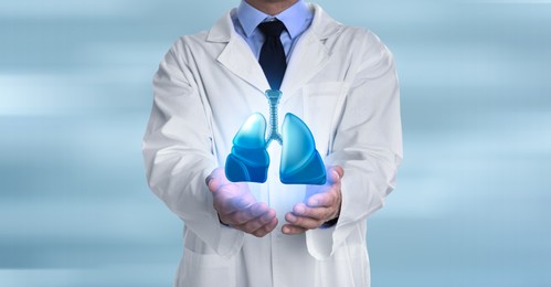 Image of Doctor demonstrating digital image of human lungs on light background, closeup. Banner design