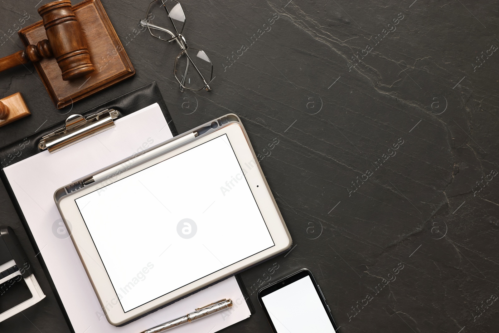 Photo of Flat lay composition with modern tablet on dark gray textured table. Space for text