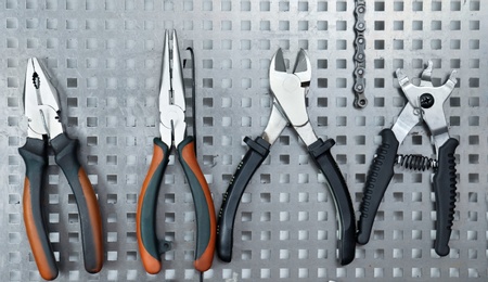 Photo of Set of different tools for bicycle repairing on stand