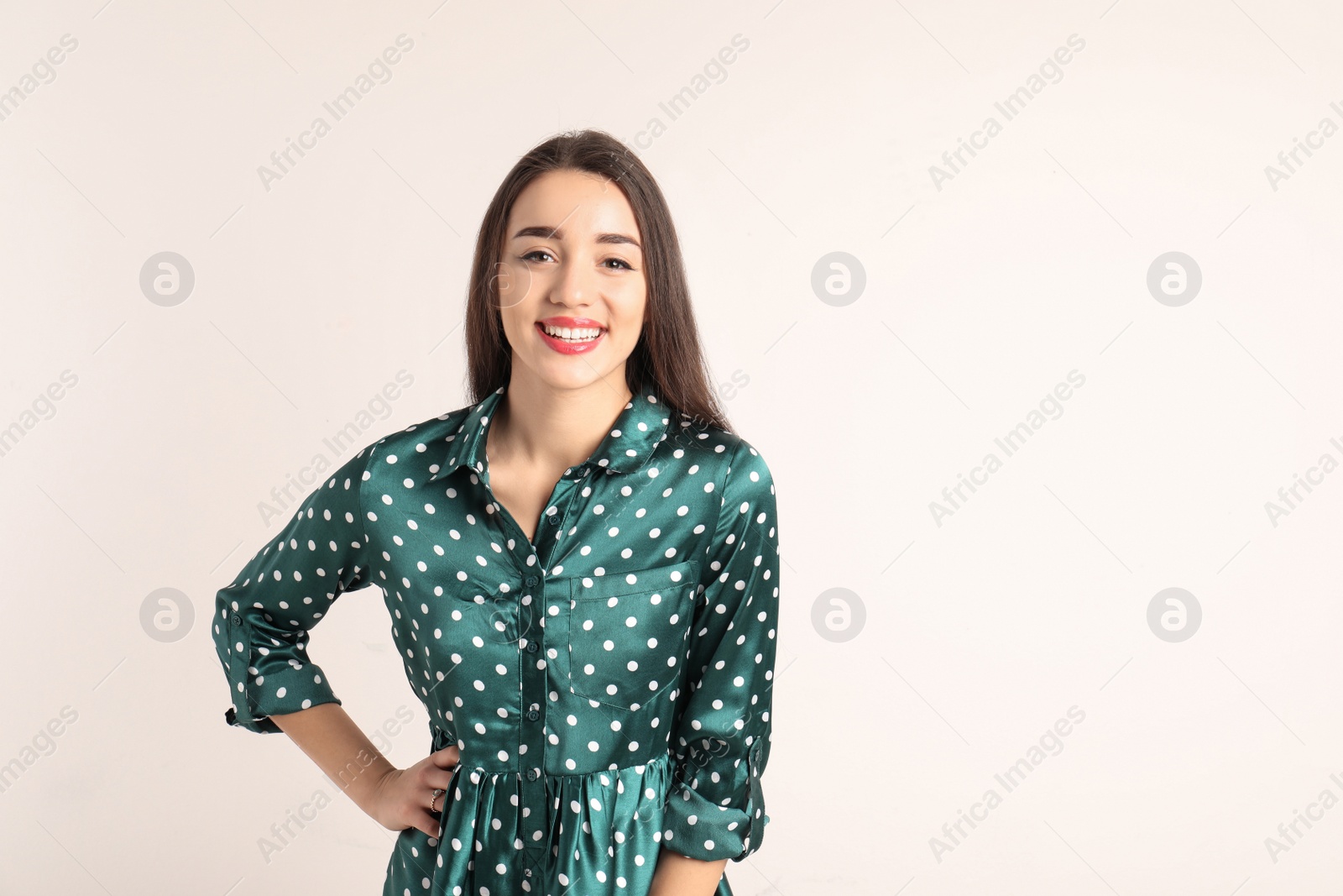 Photo of Portrait of beautiful young woman in stylish dress on white background. Space for text