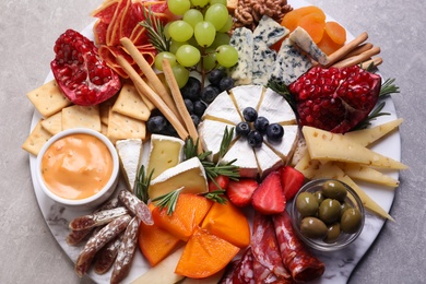 Photo of Assorted appetizers served on light grey table, view from above