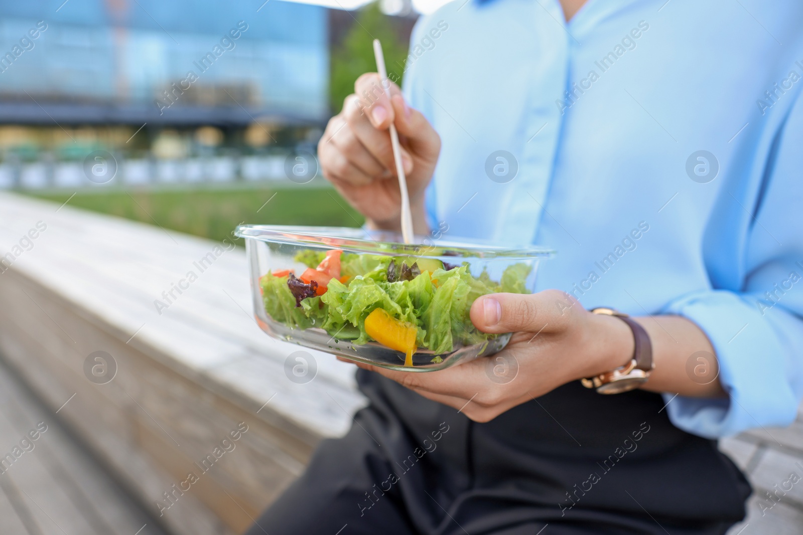 Photo of Businesswoman eating lunch during break outdoors, closeup