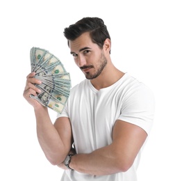 Handsome young man with dollars on white background