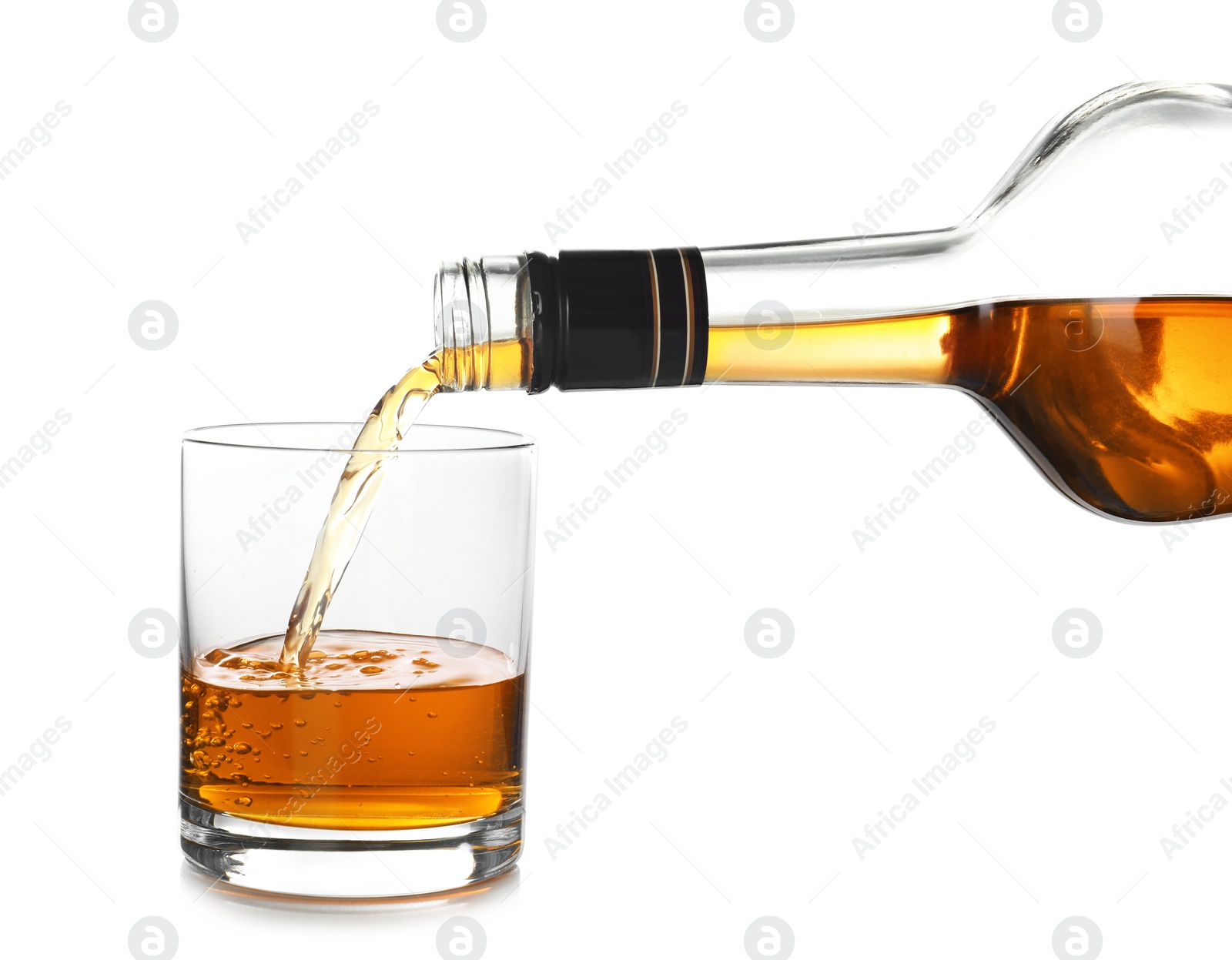 Photo of Pouring expensive whiskey into glass on white background