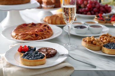 Variety of snacks on white marble table in buffet style