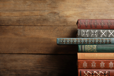 Collection of different books on wooden background. Space for text