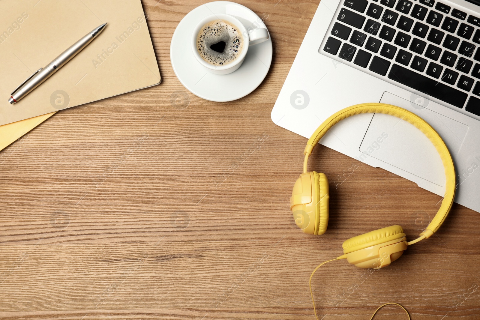 Photo of Flat lay composition with headphones, laptop and space for text on wooden background